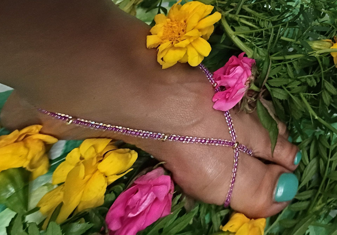 Colorful Barefoot Blooms beaded jewelry styled with flowers