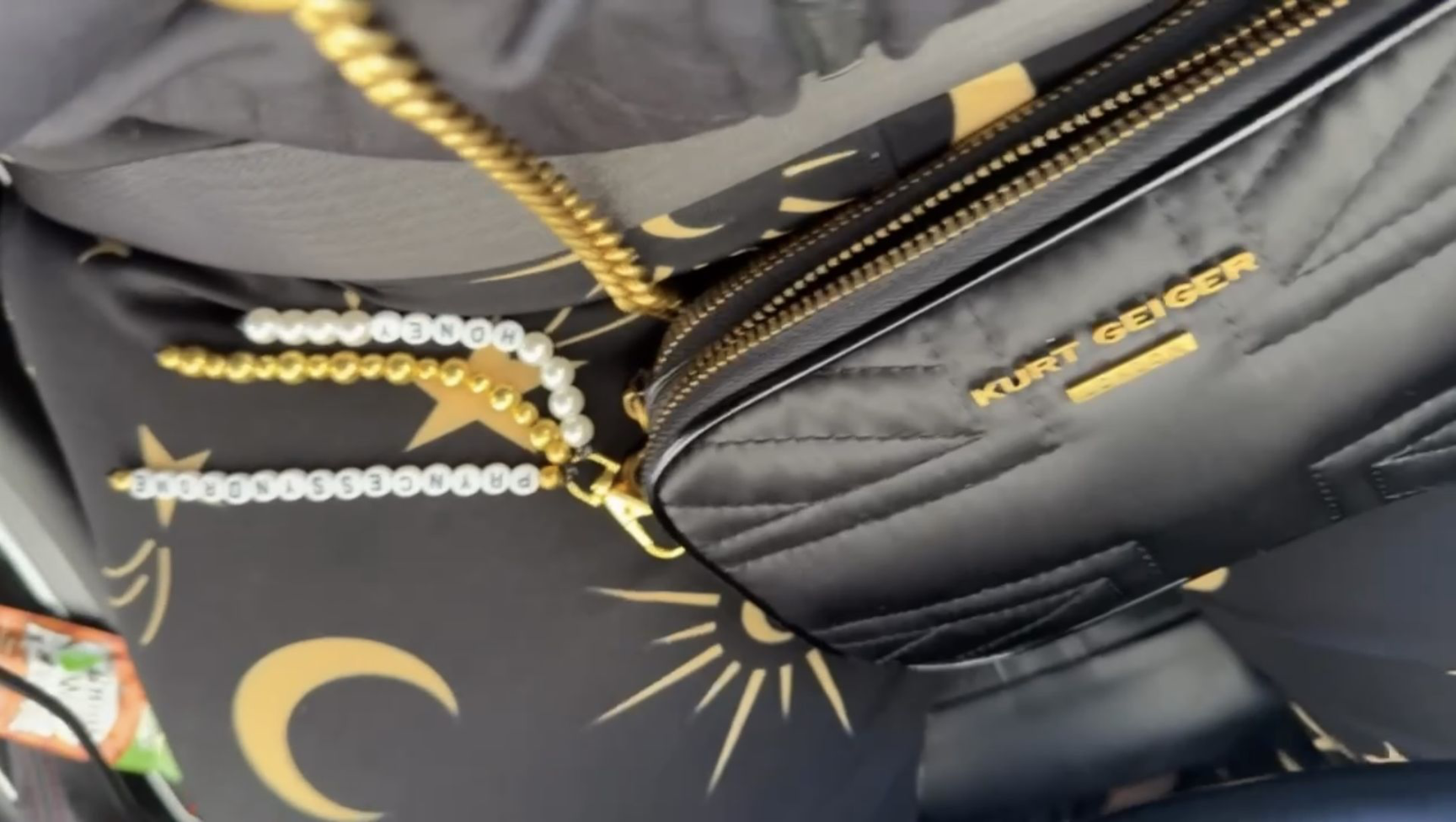 Black Kurt Geiger handbag with gold chain and charm accessories