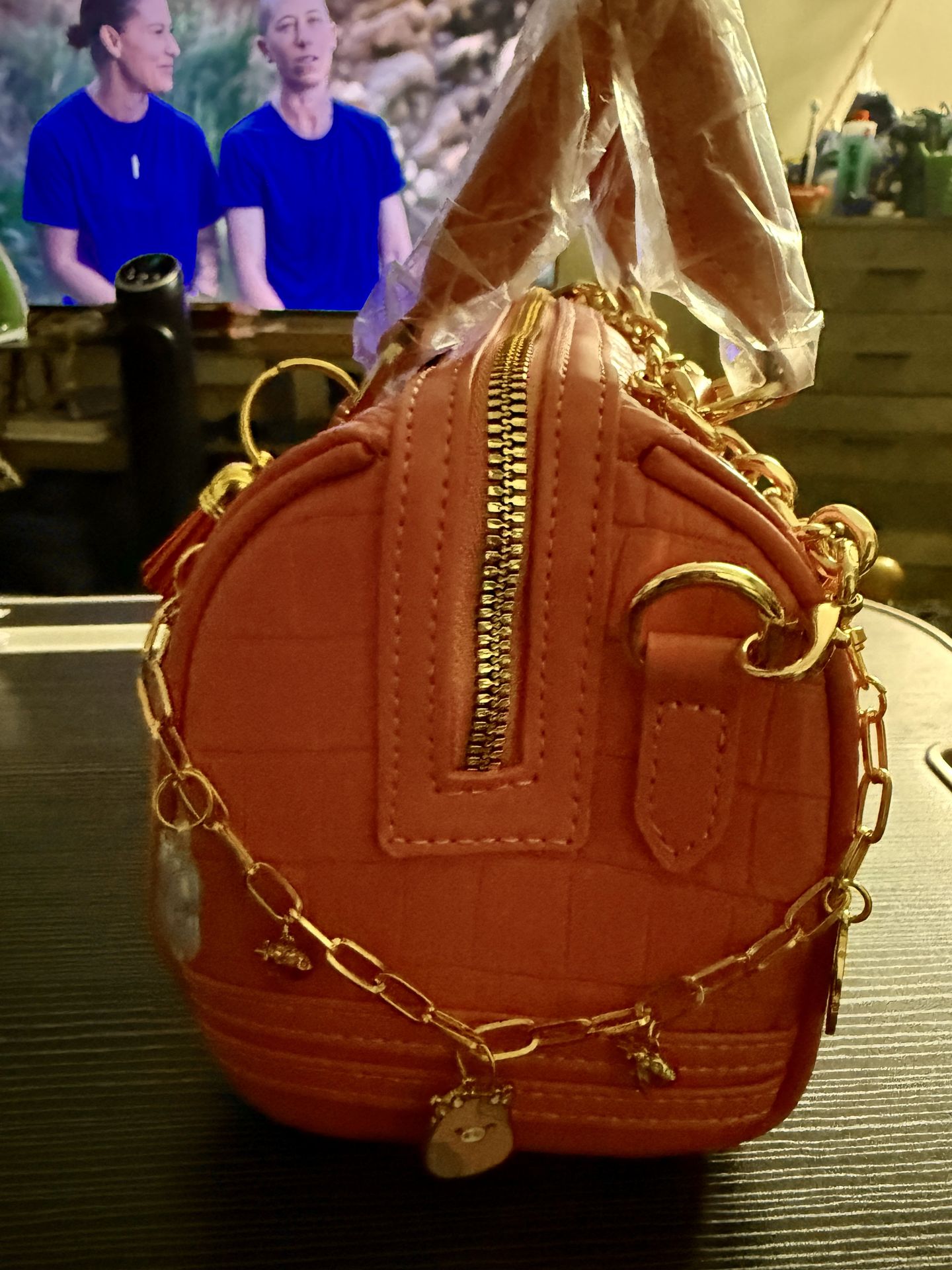 Side view pink Tote &amp; Carry handbag with handmade gold charm accessories