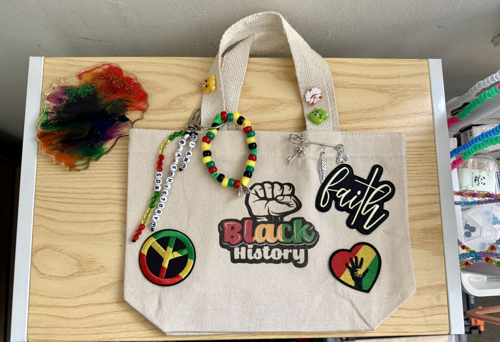 Canvas tote bag styled with colorful handmade charms