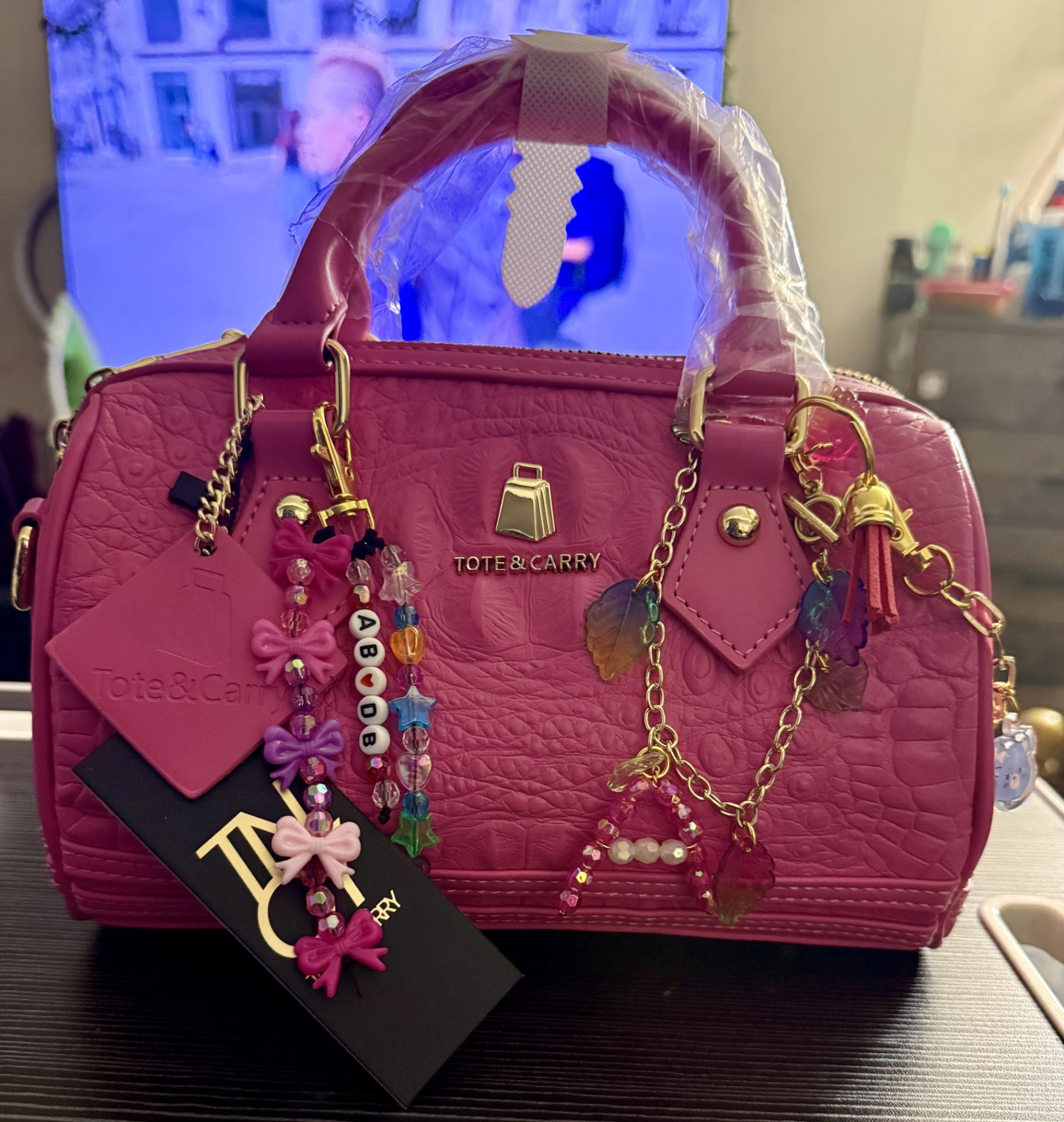 Front view pink Tote &amp; Carry handbag styled with handmade dangling purse charms