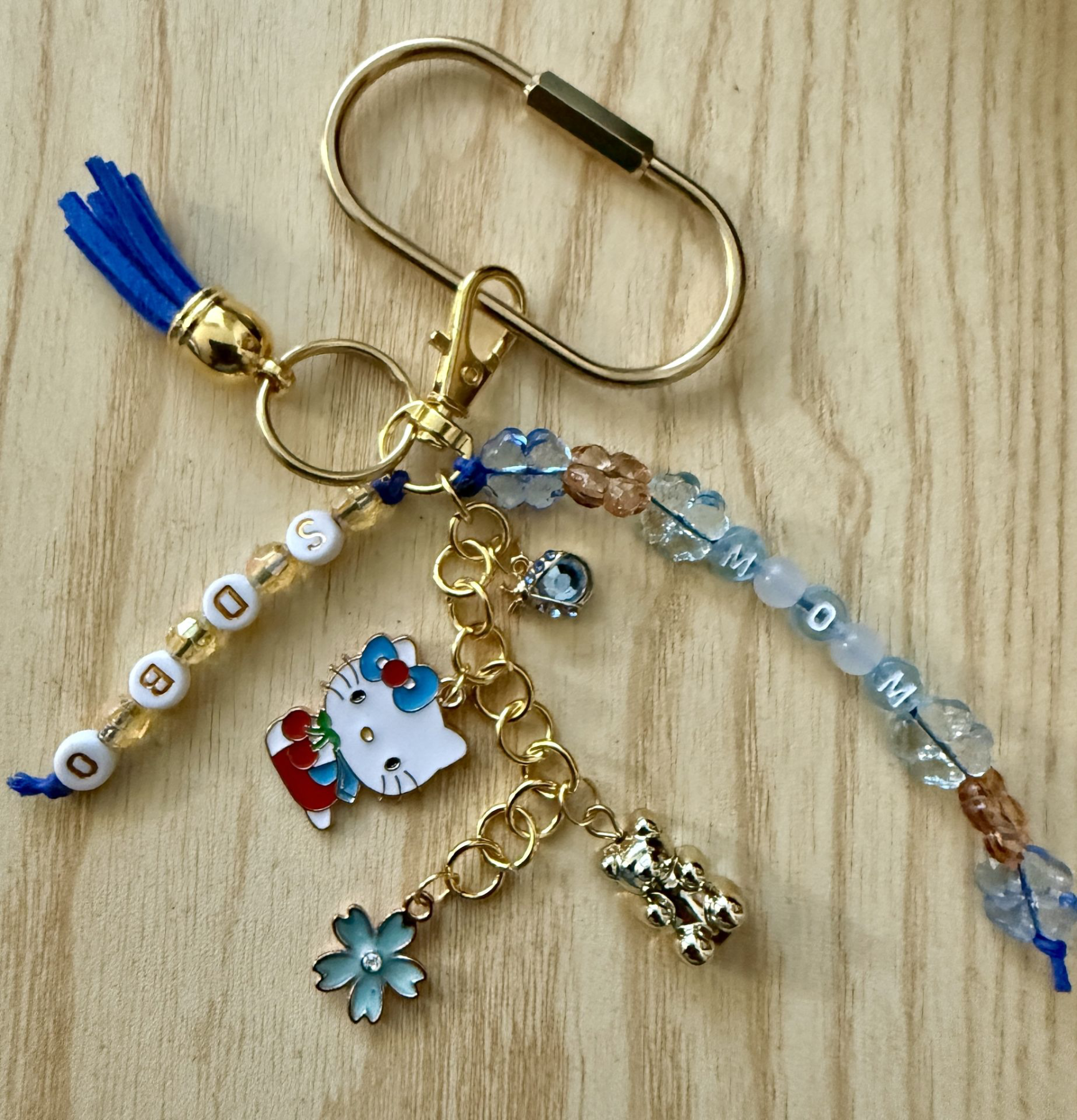Handmade blue and gold decorative keychain with charms